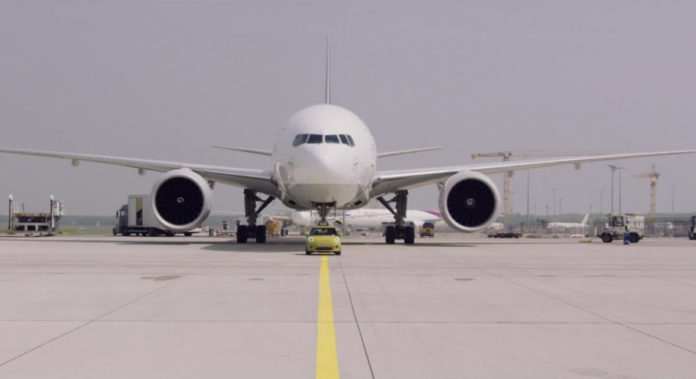 All-electric MINI Cooper SE towing a Boeing 777F